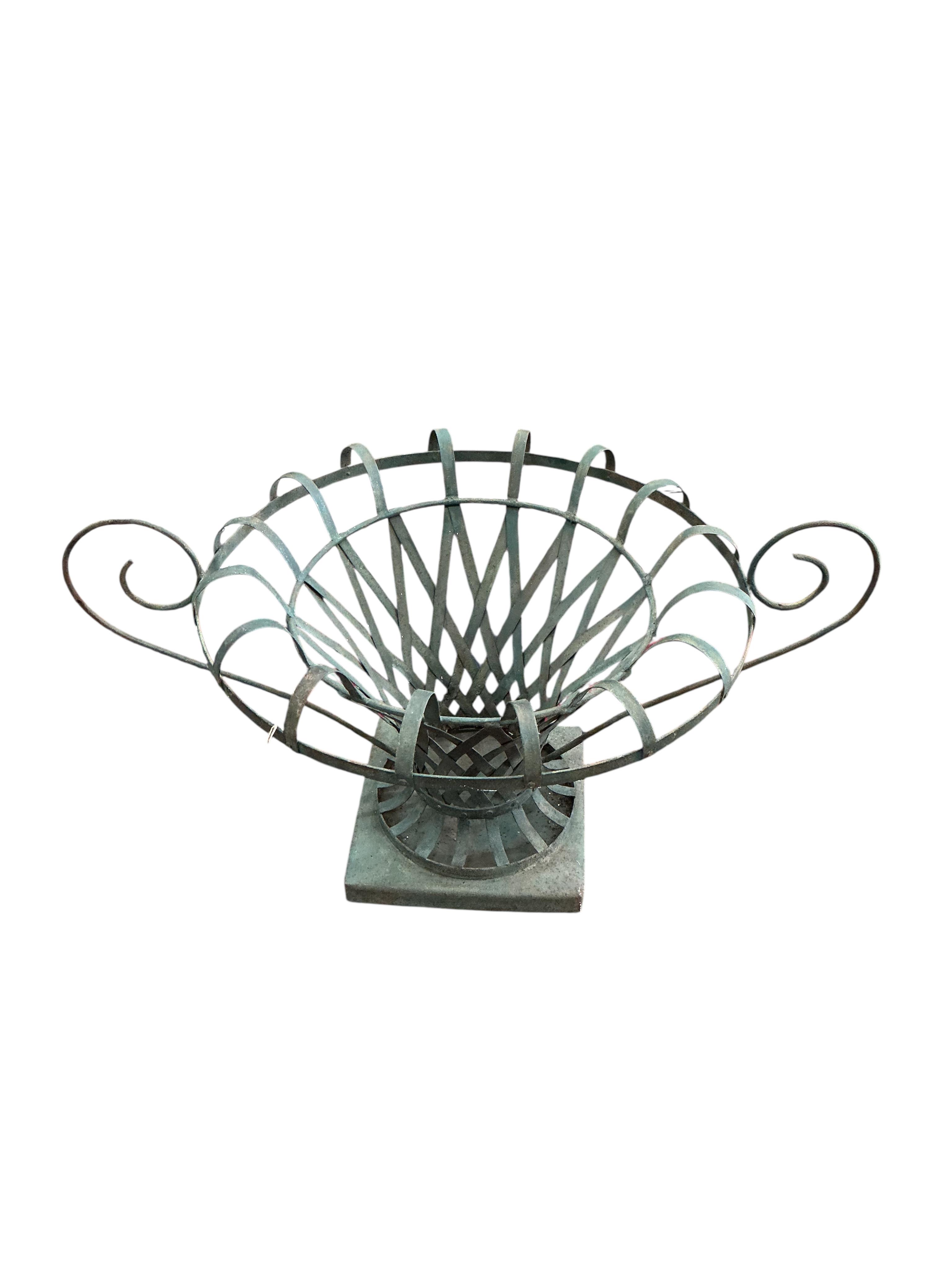 A pair of large painted wrought iron strapwork flower urns, diameter 90cm, height 44cm